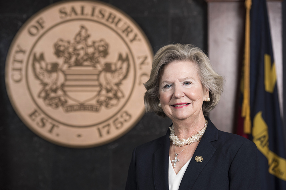 Portrait of Mayor Karen Alexander in front of city seal
